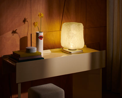 Lampe à poser Wax, Stone, Light de Linde Freya Tangelder - Cassina-allumée sur une console, avec vase et livres-Cassina