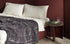 Plaid réversible Bluesky - Cassina-plaid en velours gris posé sur un lit-Cassina