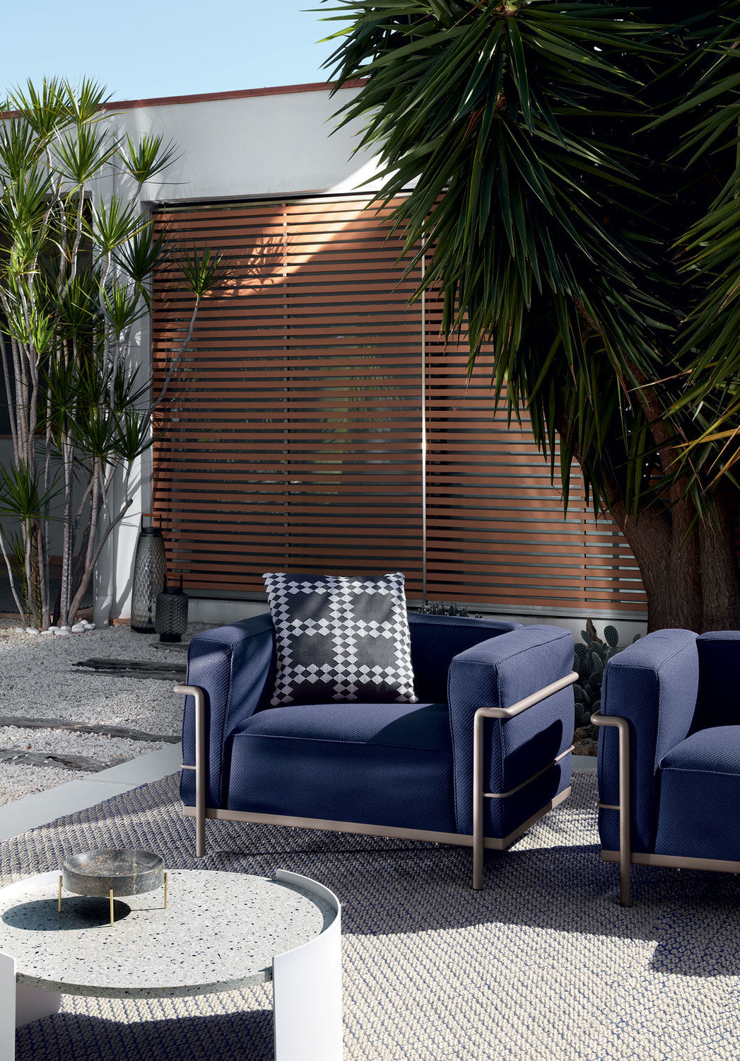 Fauteuil 3 Grand Confort (LC3) grand modèle, Outdoor - Cassina-fauteuils bleu marine sur une terrasse-The Woods Gallery