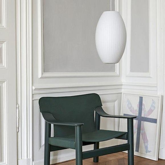 Suspension "Cigar Bubble Pendant" de George Nelson - Hay-suspendue dans une pièce avec un fauteuil vert-The Woods Gallery